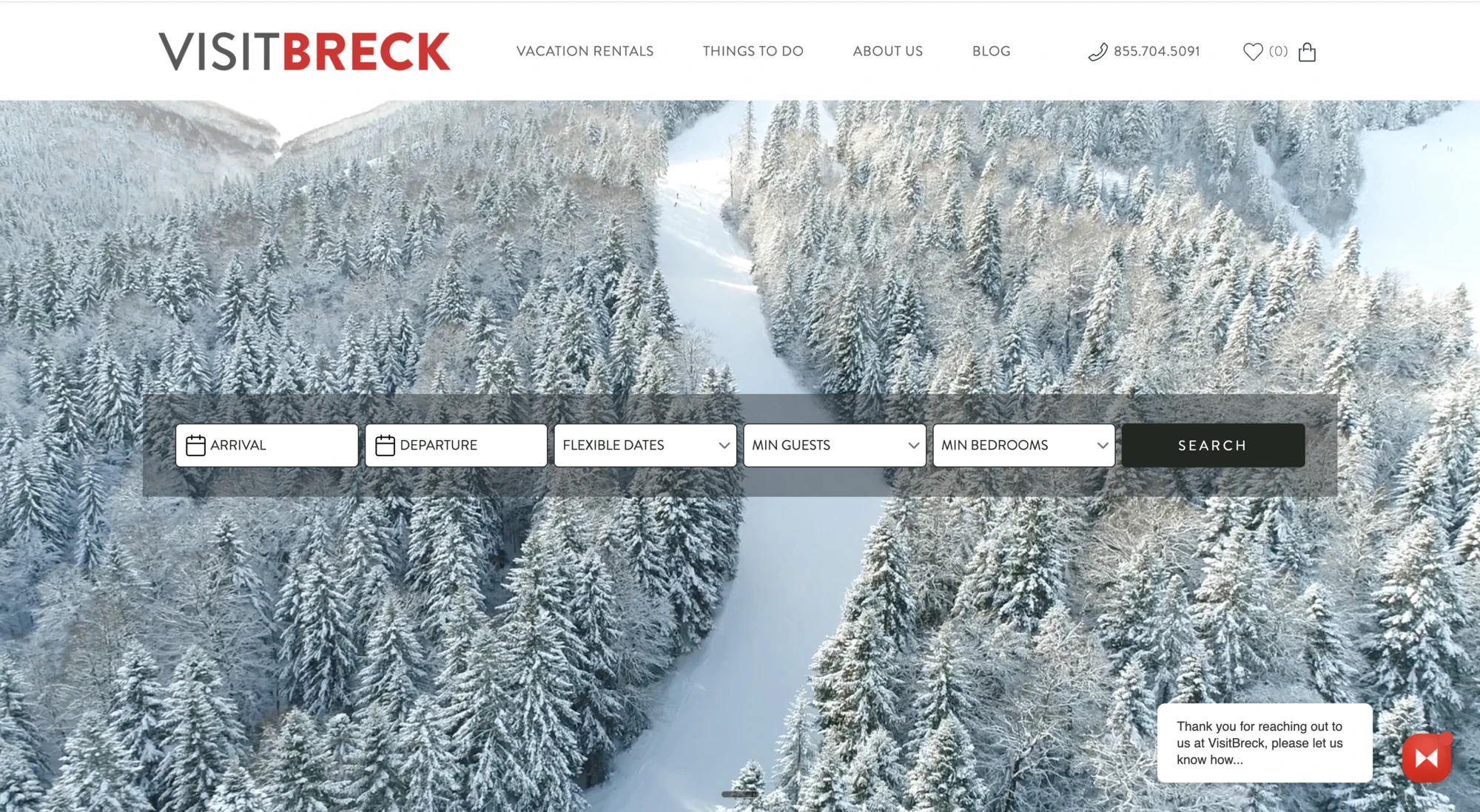 VisitBreck website with a snowy forest backdrop and vacation rental search
