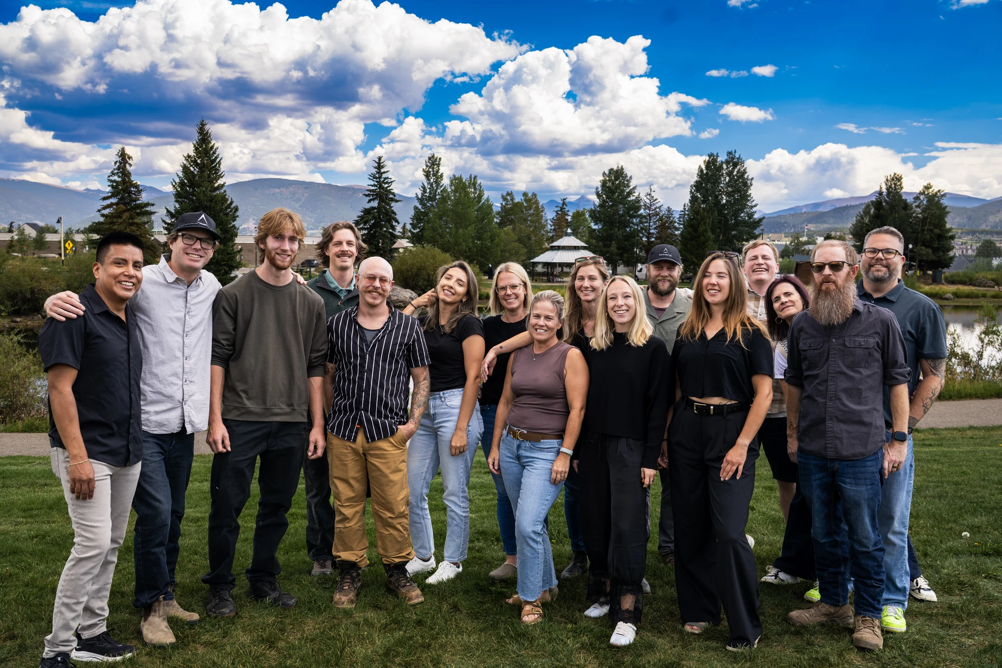 The Pinnacle team gathered outdoors in front of the Colorado mountains